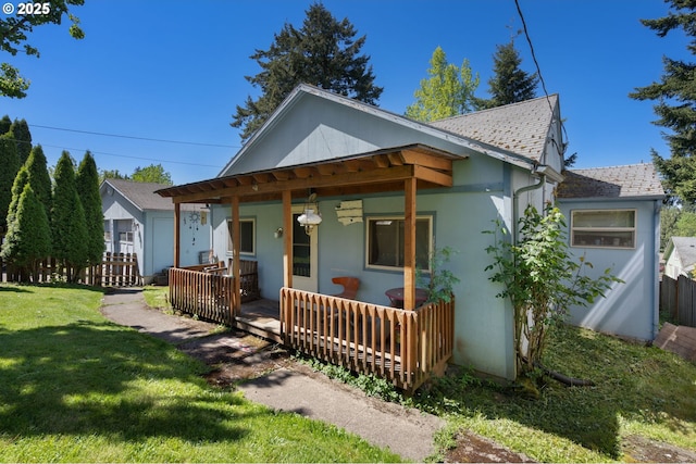 view of front of property with stucco siding, covered porch, and roof with shingles