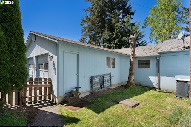 view of home's exterior with a lawn and cooling unit