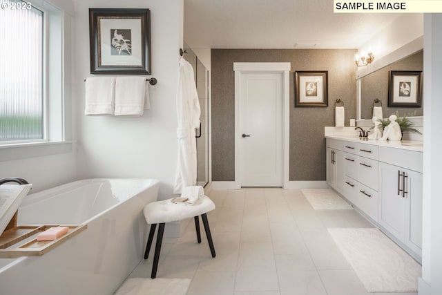 bathroom with vanity and a bath