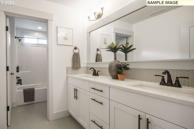 bathroom featuring tasteful backsplash, tile patterned floors, bathing tub / shower combination, and vanity