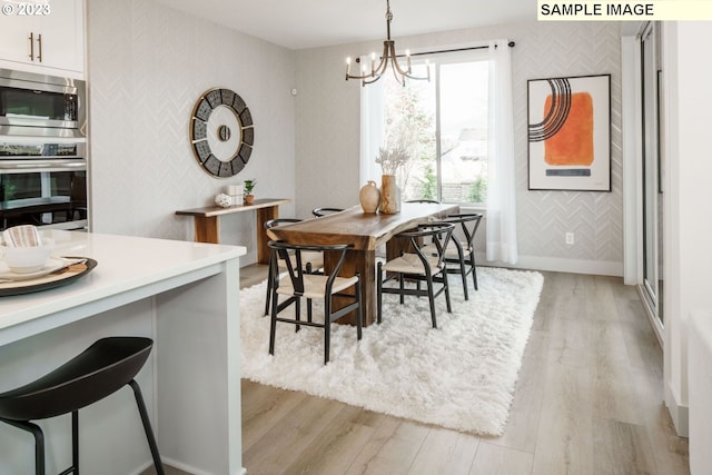 dining room featuring a chandelier and light wood-type flooring