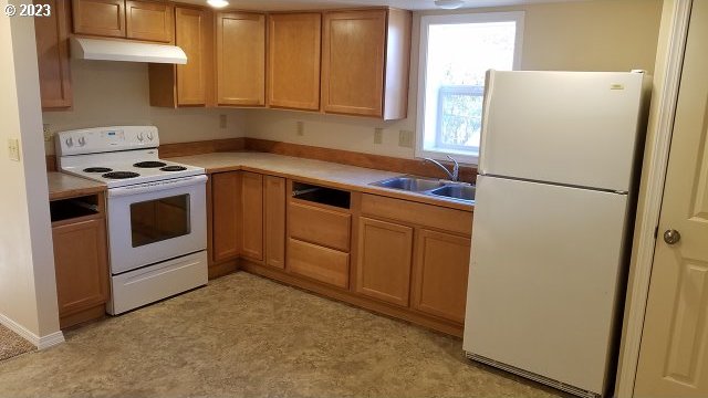 kitchen with white appliances and sink