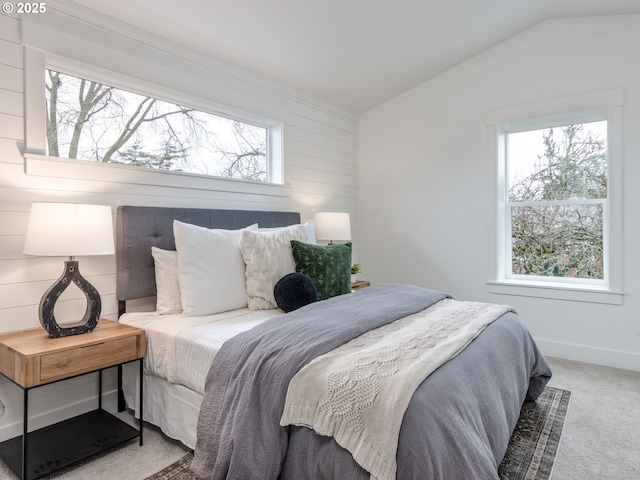 bedroom featuring baseboards, carpet, and vaulted ceiling