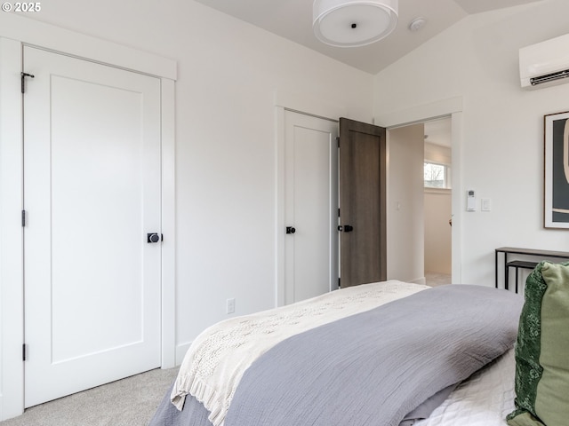 bedroom featuring vaulted ceiling, light colored carpet, and a wall mounted AC