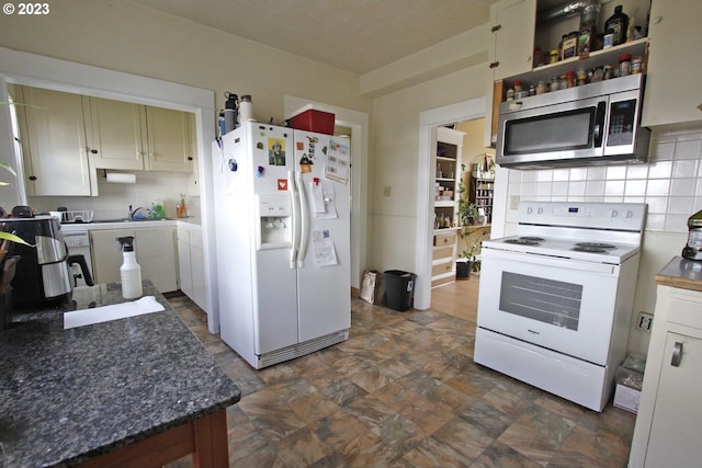 kitchen featuring tasteful backsplash, white cabinetry, and white appliances