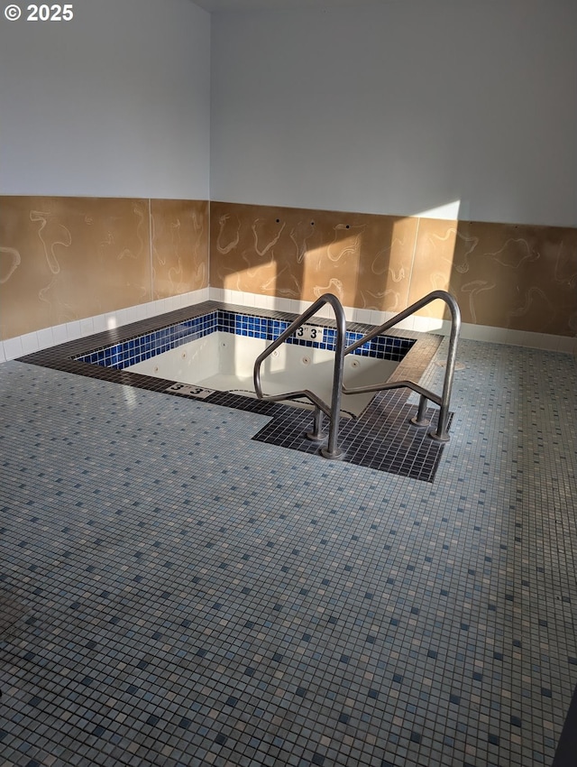 view of swimming pool featuring an indoor hot tub