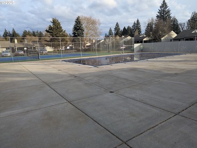 view of swimming pool featuring tennis court