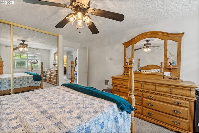 bedroom featuring a ceiling fan, a textured ceiling, light colored carpet, and a closet