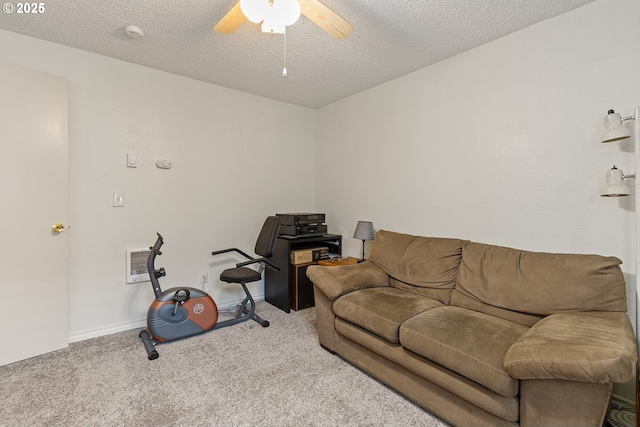 living room with carpet floors, visible vents, baseboards, ceiling fan, and a textured ceiling
