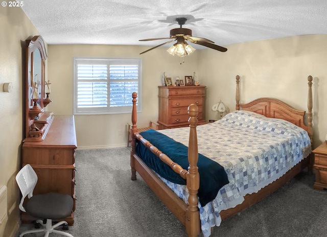 bedroom featuring ceiling fan, dark carpet, and a textured ceiling