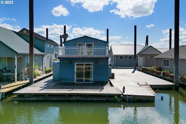 back of house featuring a water view and a balcony