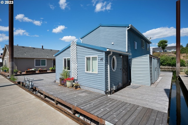 rear view of house featuring a wooden deck