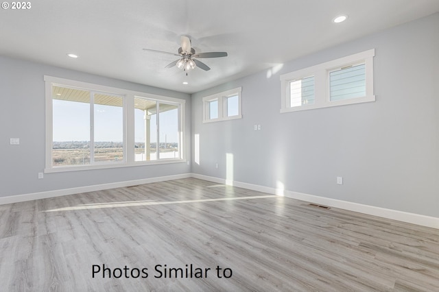 spare room with light hardwood / wood-style flooring and ceiling fan