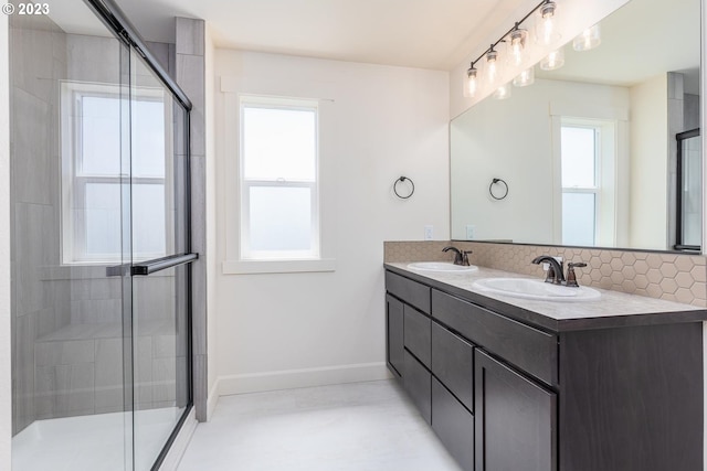 bathroom with walk in shower, dual bowl vanity, and a wealth of natural light