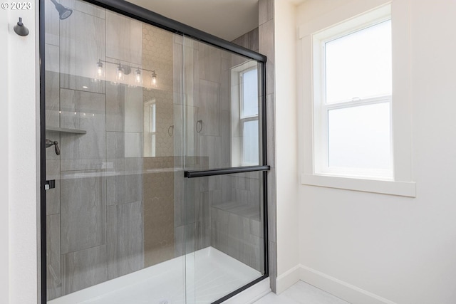 bathroom with an enclosed shower and tile flooring