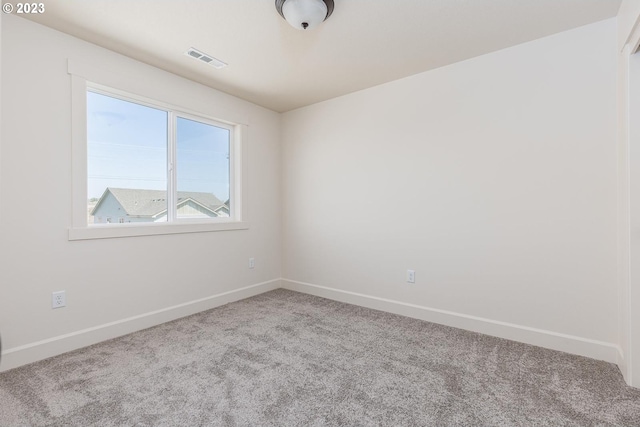 unfurnished room featuring light colored carpet