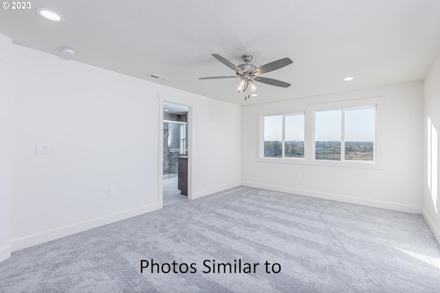 empty room with light carpet and ceiling fan