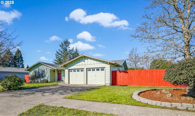 view of front of home with aphalt driveway, an attached garage, fence, a front lawn, and board and batten siding