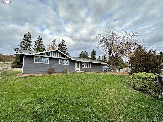 rear view of property with a yard