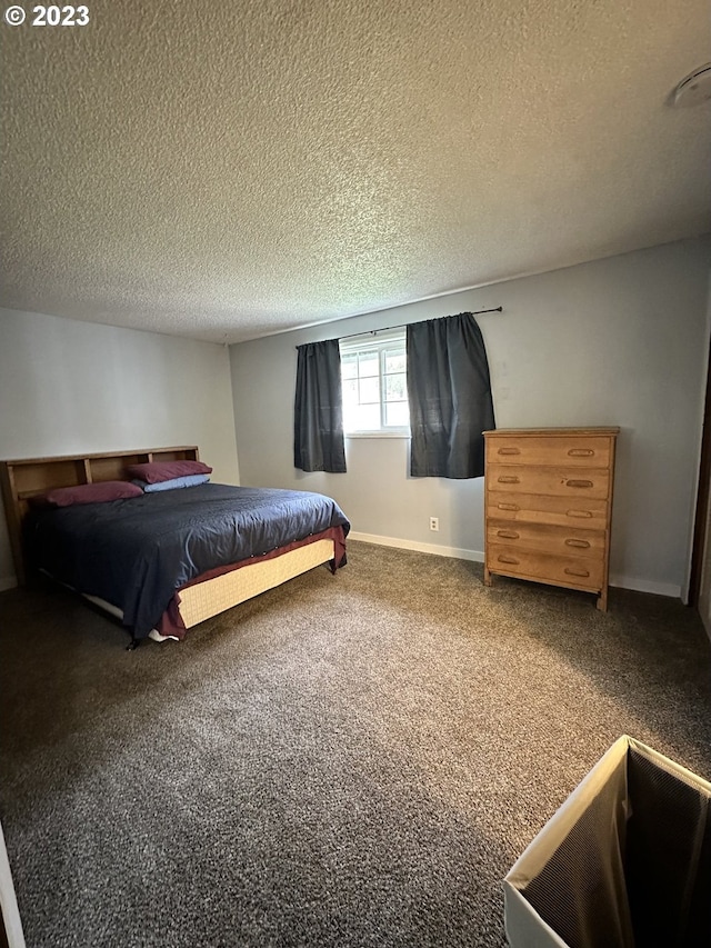 bedroom with carpet floors and a textured ceiling