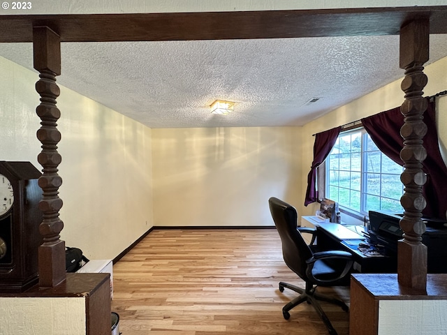 office featuring hardwood / wood-style flooring and a textured ceiling