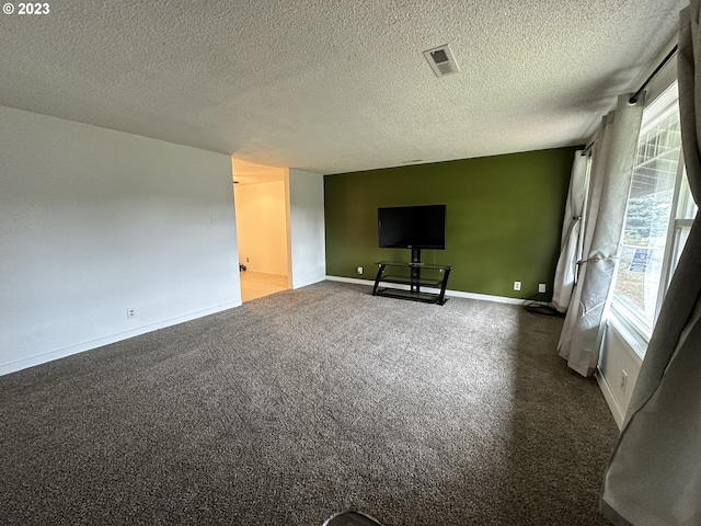 unfurnished living room featuring a textured ceiling and carpet