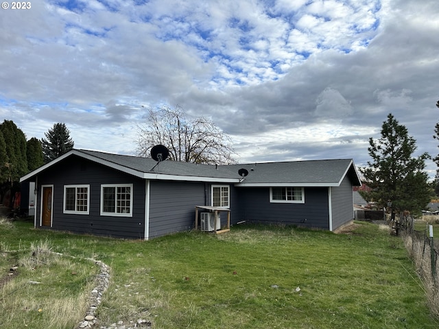 rear view of property featuring a yard