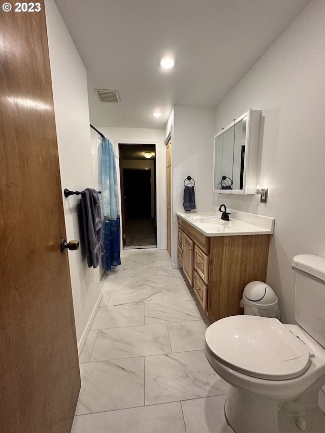 bathroom with vanity, a shower with curtain, and toilet