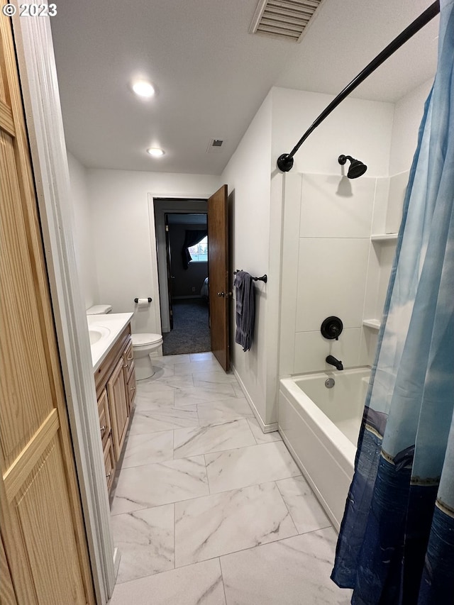 full bathroom featuring vanity, shower / bath combo, and toilet