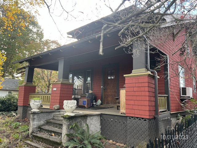 view of side of property featuring covered porch