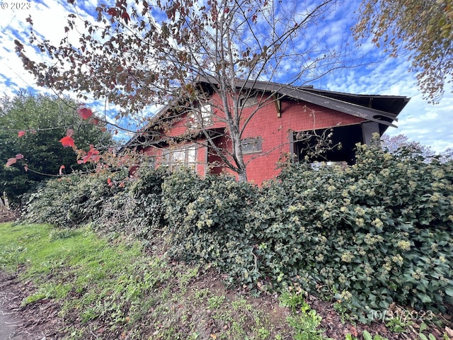 view of property exterior with brick siding