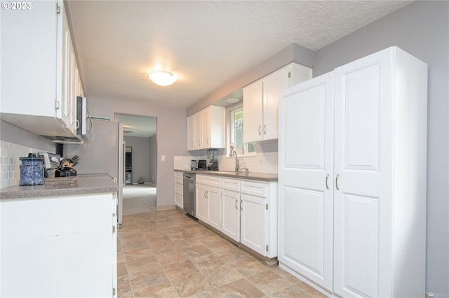 kitchen with sink, white cabinets, and tasteful backsplash