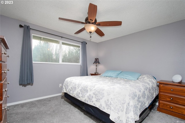 carpeted bedroom featuring a textured ceiling and ceiling fan