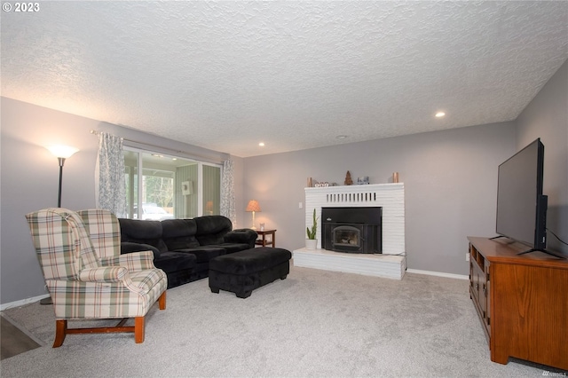 living room featuring a brick fireplace, a textured ceiling, and light carpet