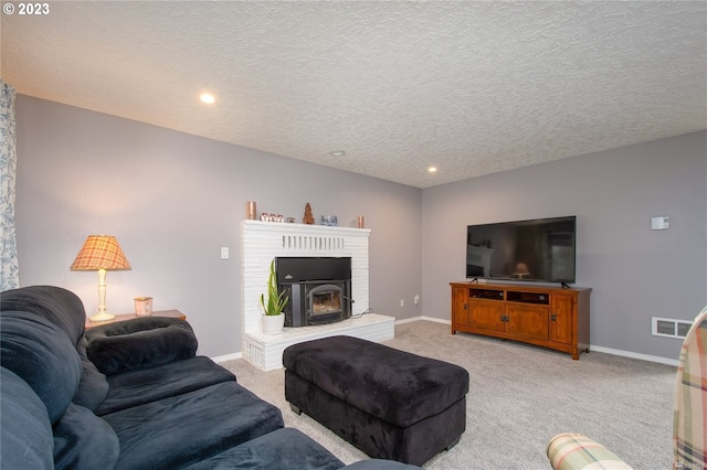 living room featuring a fireplace, light carpet, and a textured ceiling