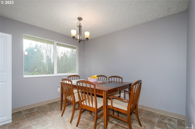 dining room with a notable chandelier and a textured ceiling