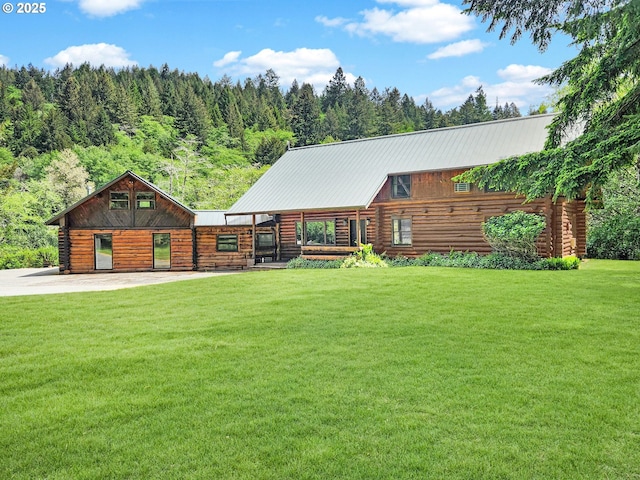 17285 Rustic Ln, Brookings, OR 97415 - cabin featuring log exterior, a front lawn, and metal roof