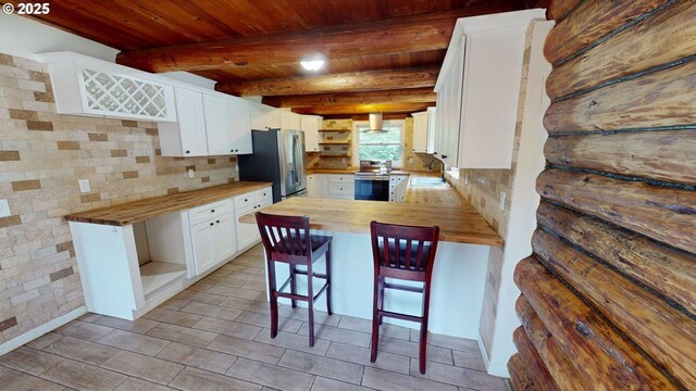 17285 Rustic Ln, Brookings, OR 97415 - kitchen featuring wood counters, open shelves, stainless steel appliances, a sink, and a peninsula