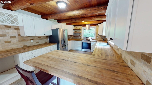 17285 Rustic Ln, Brookings, OR 97415 - kitchen with appliances with stainless steel finishes, a sink, wood counters, open shelves, and white cabinets