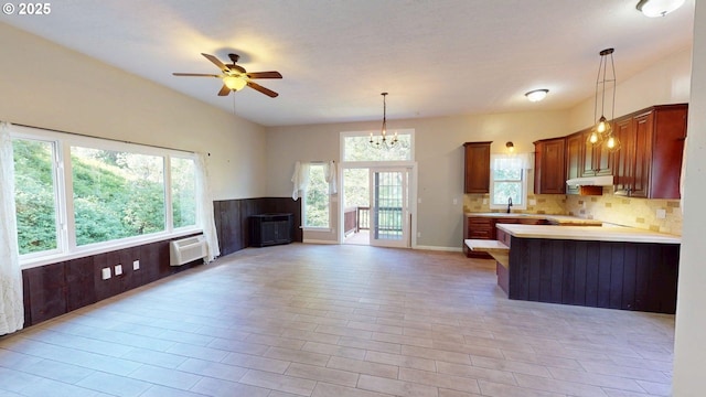 17285 Rustic Ln, Brookings, OR 97415 - kitchen featuring open floor plan, light countertops, a sink, decorative backsplash, and a ceiling fan