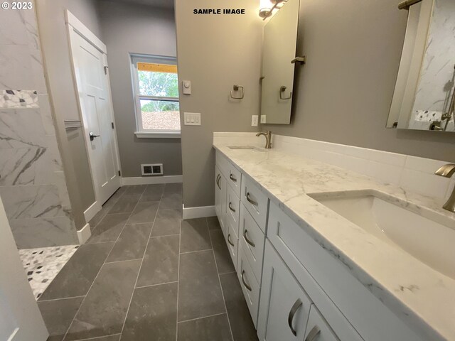 bathroom with tile flooring, double sink, and oversized vanity