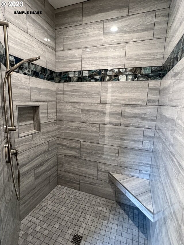 bathroom with tiled shower