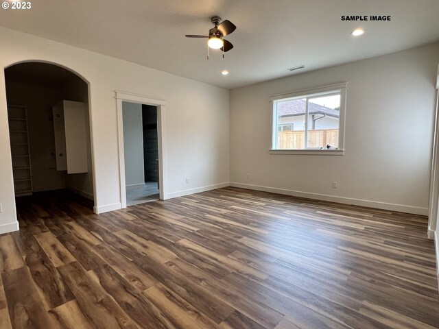 empty room featuring ceiling fan and dark hardwood / wood-style flooring