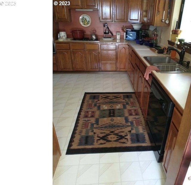 kitchen with sink and black appliances