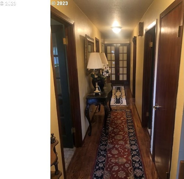 hallway featuring dark hardwood / wood-style flooring and french doors