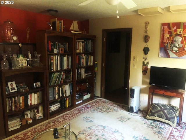 home office featuring ceiling fan and a textured ceiling