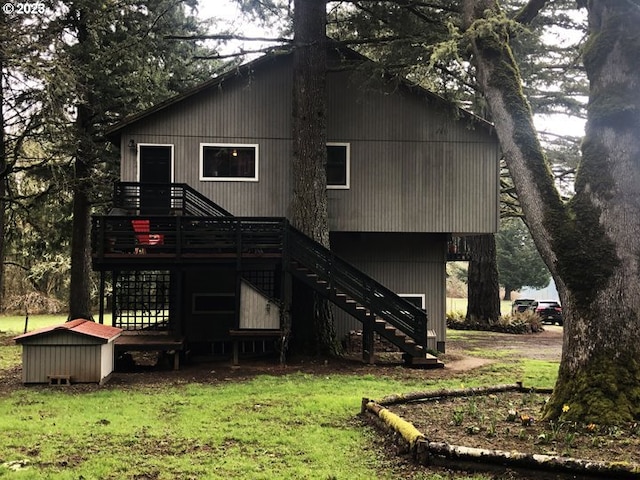 rear view of property with a lawn and a deck