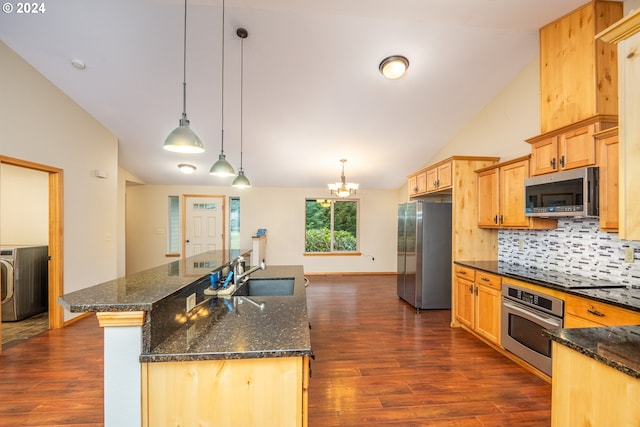 kitchen with dark hardwood / wood-style flooring, stainless steel appliances, sink, washer / clothes dryer, and hanging light fixtures