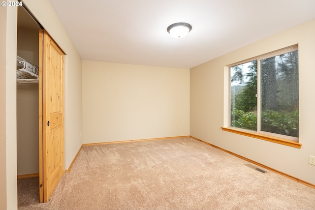 unfurnished bedroom with carpet flooring and a closet