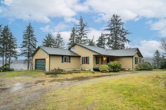ranch-style house with a garage and a front lawn